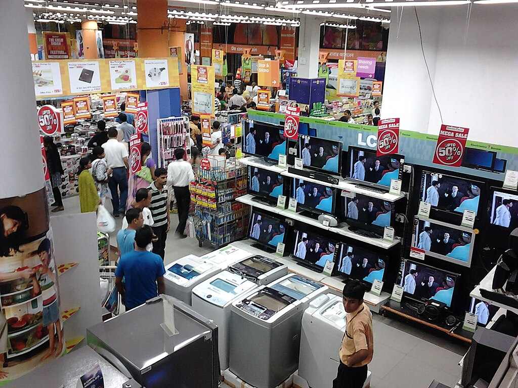 Big Bazaar store interior at Esplanade, Kolkata, showing shoppers among refrigerators, TVs, and appliances on display.