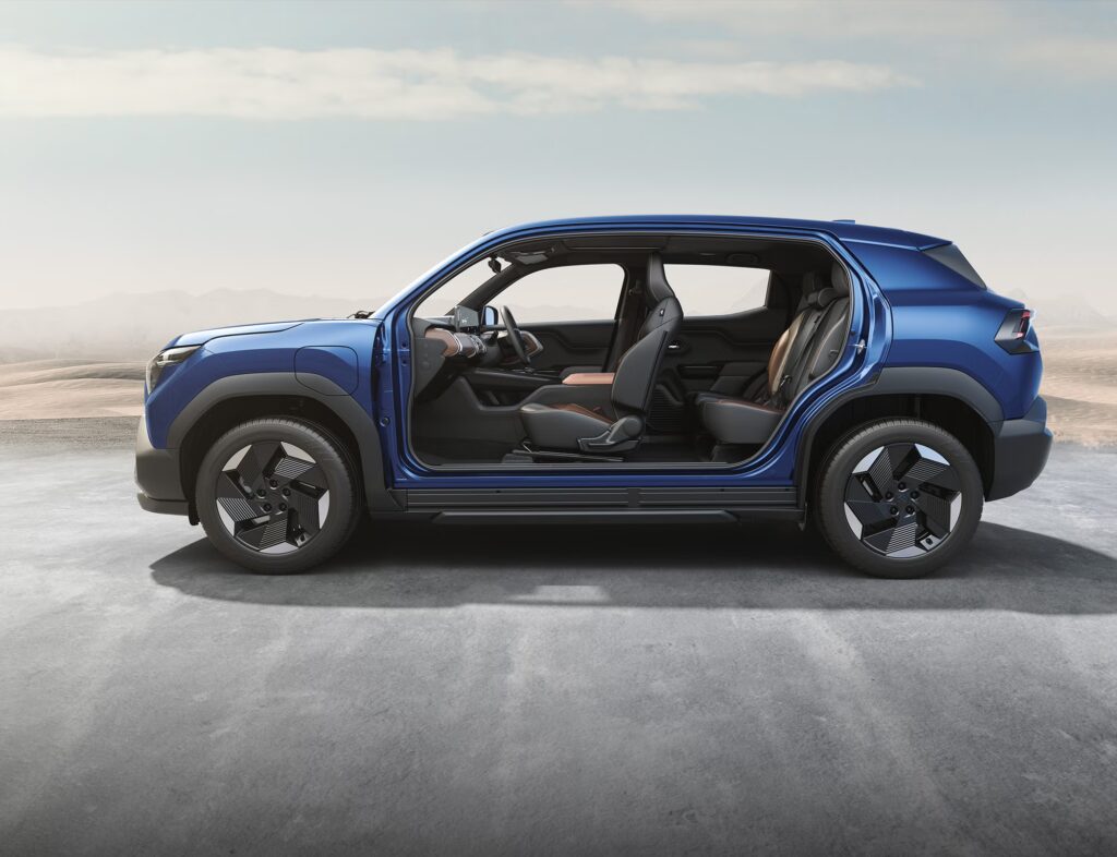 Side cutaway view of blue Maruti e VITARA showing interior cabin layout with front and rear seats, displaying the spacious interior and door configuration