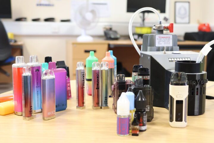 A pile of colorful, confiscated vape pens collected from secondary schools in England, many of which were found to contain dangerous synthetic cannabinoids.