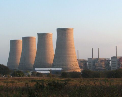 Chapelcross Nuclear Power Station in Scotland with its four distinctive cooling towers against a cloudy sky