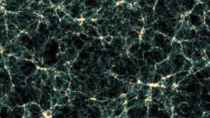 Visualization of the cosmic web from the Flagship 2 simulation showing the network-like structure of dark matter and galaxy distribution throughout the universe, with bright yellow-white nodes connected by thin filaments against a black background.