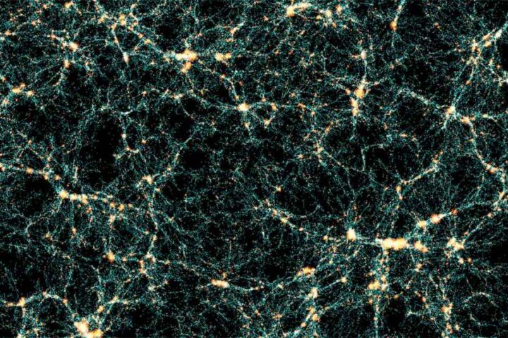 Visualization of the cosmic web from the Flagship 2 simulation showing the network-like structure of dark matter and galaxy distribution throughout the universe, with bright yellow-white nodes connected by thin filaments against a black background.