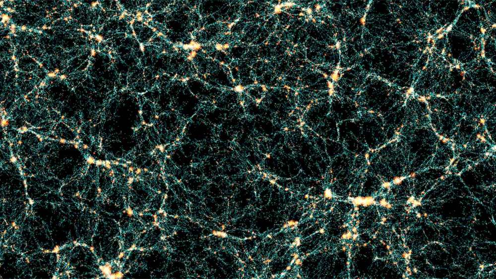 Visualization of the cosmic web from the Flagship 2 simulation showing the network-like structure of dark matter and galaxy distribution throughout the universe, with bright yellow-white nodes connected by thin filaments against a black background.