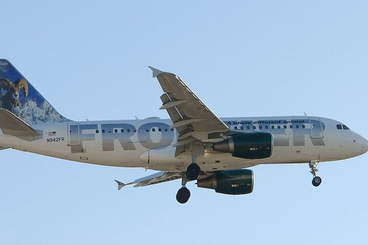 Frontier Airlines Airbus A319 aircraft with its distinctive animal livery featuring a bird on the tail fin approaching landing with landing gear down.