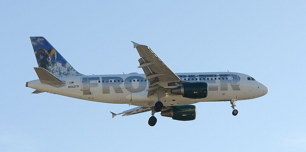 Frontier Airlines Airbus A319 aircraft with its distinctive animal livery featuring a bird on the tail fin approaching landing with landing gear down.