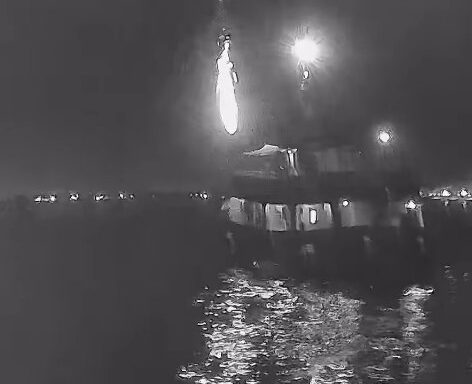 Nighttime video still showing the Global Sumud Flotilla’s Family Boat on fire while docked in Tunisian waters, with flames visible against the dark sky.