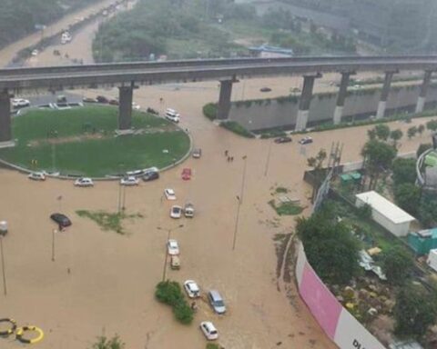 Flooded Gurgaon underpass with cars stranded in brown rainwater after heavy monsoon rainfall, highlighting poor drainage and urban flooding issues.