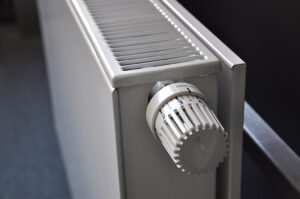 Close-up photograph of a home radiator used for winter heating support context.