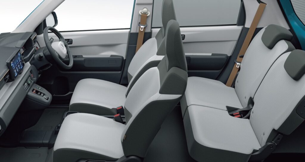 Interior view of Honda N-ONE e showing gray cabin, minimalist dashboard design, and spacious seating arrangement