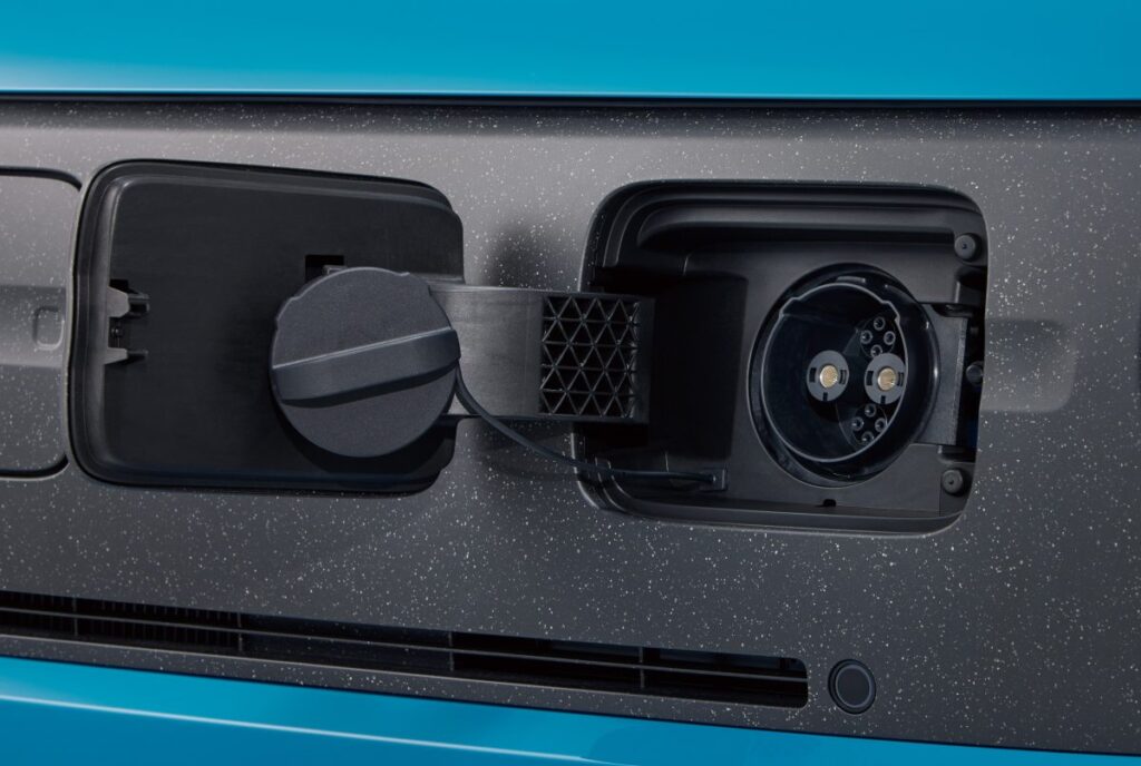 Close-up of Honda N-ONE e front charging port with cable connected, highlighting the convenient front grille placement