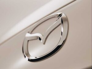 Close-up of the chrome Mazda emblem on a vehicle.