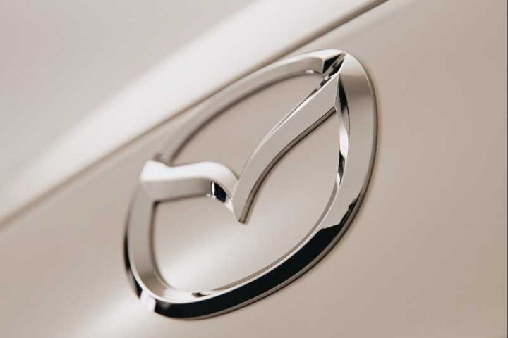 Close-up of the chrome Mazda emblem on a vehicle.
