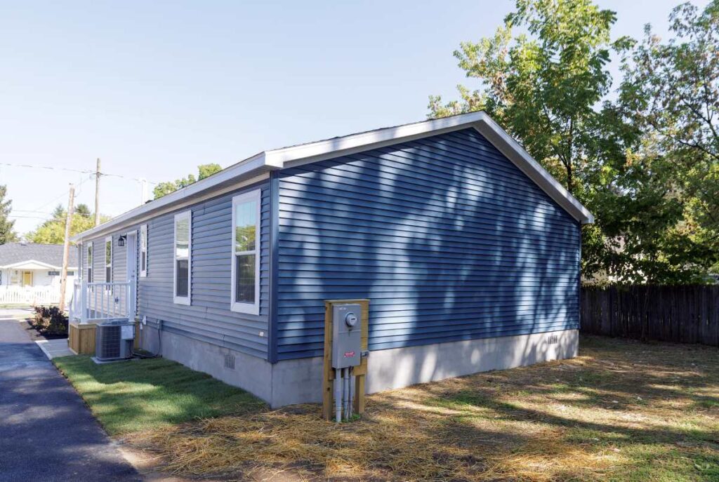 Exterior view of 3-bedroom CrossMod manufactured home showing traditional architectural features and permanent foundation installation