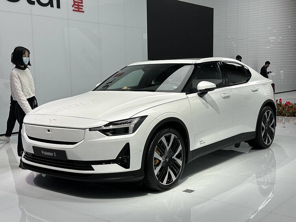 White Polestar 2 electric vehicle displayed at auto show with minimalist Scandinavian design features