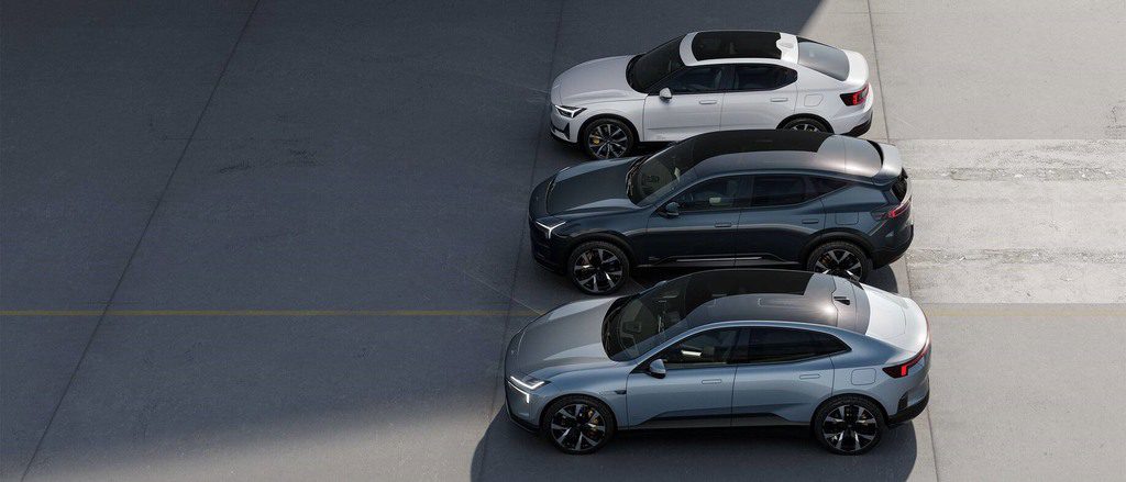 Three Polestar electric vehicles parked in a row, including the Polestar 2 sedan and Polestar 3 SUV, showcasing the company's premium EV lineup.