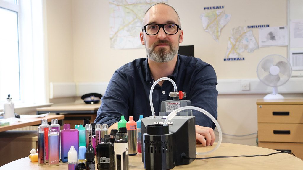 Professor Chris Pudney of the University of Bath holds a chart showing data from his team's study on spice in school-confiscated vapes.