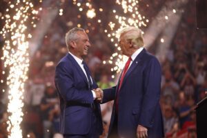 Robert F. Kennedy Jr. and former President Donald Trump speaking together on stage at a rally in Arizona.