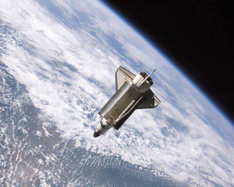 Space shuttle orbiting Earth against the backdrop of clouds and atmosphere, demonstrating the harsh environment where stem cells experience accelerated aging