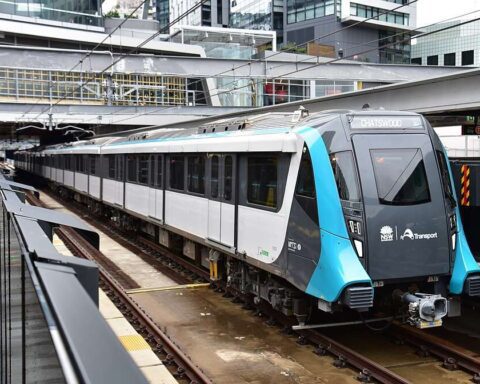 A modern, fully automated Sydney Metro train stopped at the platform of Chatswood Station, a key junction in the network's power supply infrastructure.