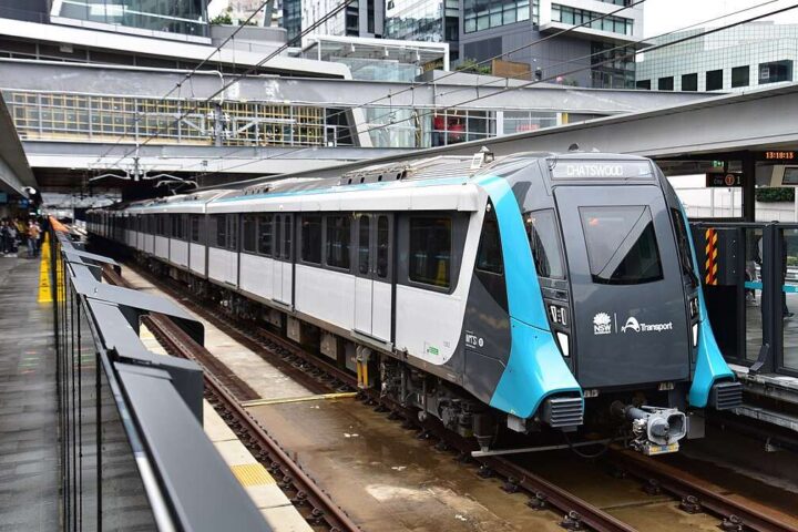 A modern, fully automated Sydney Metro train stopped at the platform of Chatswood Station, a key junction in the network's power supply infrastructure.