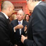 A business leader speaking with attendees at the World Economic Forum in Davos, photographed during the FT CNBC Nightcap 2016.