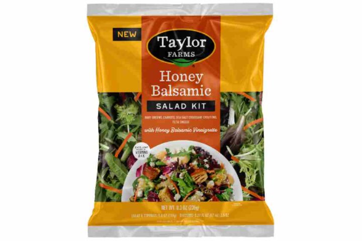 Taylor Farms Honey Balsamic Salad Kit in yellow and orange packaging showing baby greens, carrots, and feta cheese with honey balsamic vinaigrette dressing that has been recalled due to undeclared allergens.