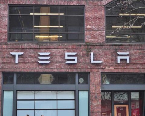 Tesla storefront on brick building at 435 Westlake North in Seattle, Washington, showing the company logo and large glass windows of the showroom.