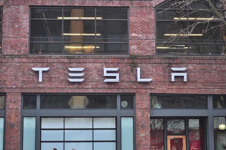 Tesla storefront on brick building at 435 Westlake North in Seattle, Washington, showing the company logo and large glass windows of the showroom.
