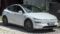 A white Tesla Model Y electric SUV parked outdoors at the MYLE Festival 2023, showing its distinctive aerodynamic profile and minimalist design.
