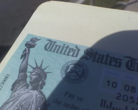Close-up of a United States Treasury Social Security check featuring the Statue of Liberty and Treasury seal.