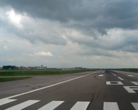 View of Runway 08-R at London Gatwick Airport showing the main runway with cloudy sky above.