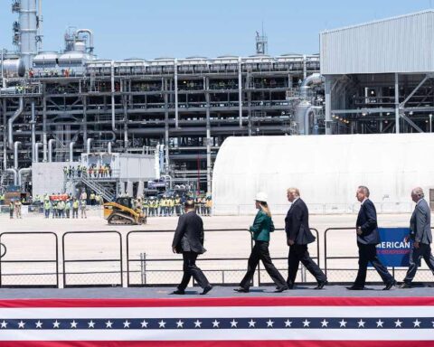 President Donald Trump and officials walk past industrial structures at the Cameron LNG Export Terminal in Hackberry, Louisiana, during a site tour on May 14, 2019.
