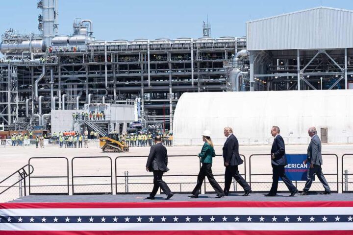 President Donald Trump and officials walk past industrial structures at the Cameron LNG Export Terminal in Hackberry, Louisiana, during a site tour on May 14, 2019.