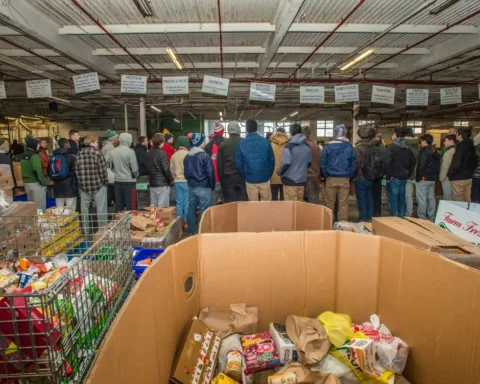 Students receiving instructions while sorting donated food at the Community FoodBank of New Jersey, part of a USDA food assistance program, January 2016.
