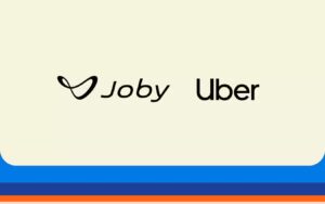 Joby and Uber logos displayed side by side on a cream-colored background with blue and orange horizontal stripes at the bottom of the image.
