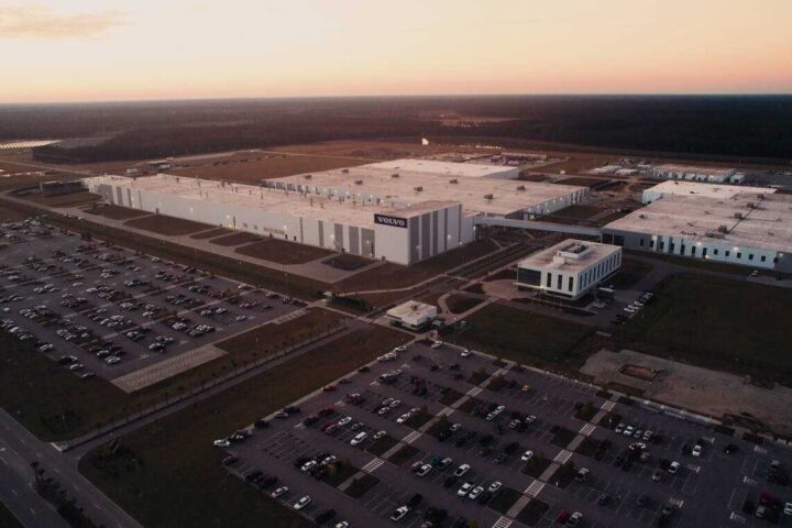 Aerial view of Volvo's Ridgeville manufacturing facility in South Carolina, showing the expansive 2.3 million square foot plant with surrounding parking lots at sunset.