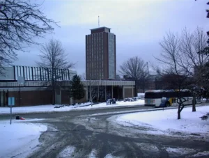 Bartle Library Tower photographed from below, showing its tall concrete structure against a cloudy sky.