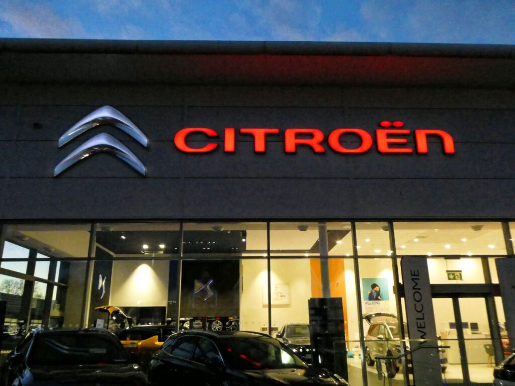 Citroën dealership storefront at night in Chingford, London with illuminated Citroën logo and branding.