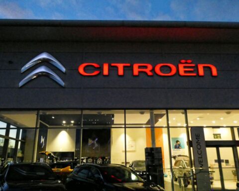 Citroën dealership storefront at night in Chingford, London with illuminated Citroën logo and branding.