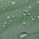 Water droplets on a green fabric surface.