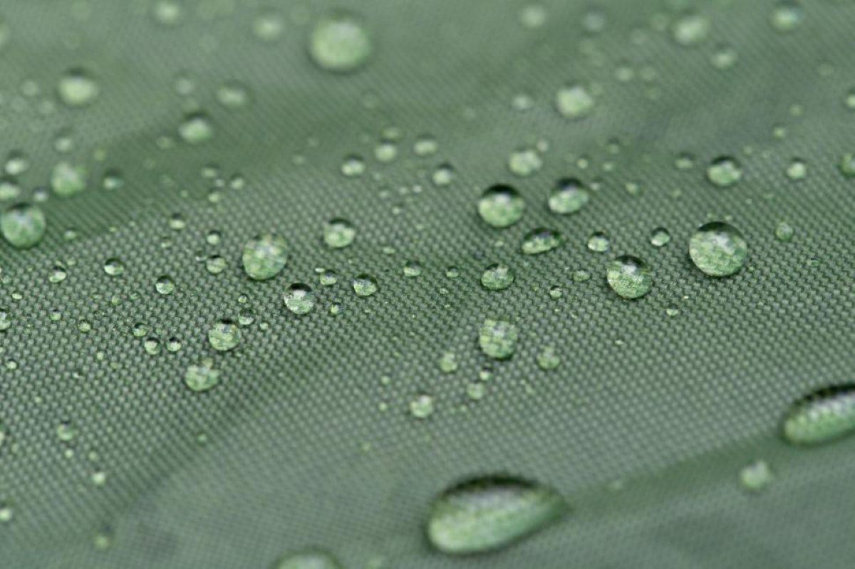 Water droplets on a green fabric surface.