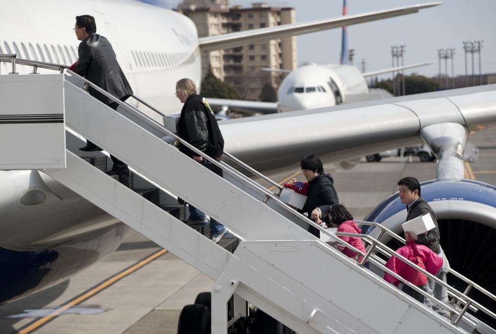 Passengers queuing to board an aircraft at an airport gate