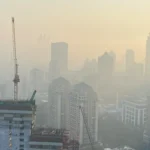 Massive dust cloud covering Mumbai skyline during evening hours as a result of construction activity and changing wind patterns.