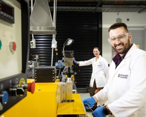Edward Attenborough and Dr Leonie van 't Hag working in a laboratory at Monash University with scientific equipment used for creating bioplastics from food waste sugars.
