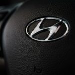 Close-up of a Hyundai logo on a black steering wheel