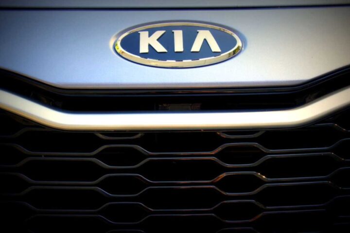 Kia emblem and front grille on a 2012 Kia Optima Hybrid showing the distinctive honeycomb pattern and oval Kia logo
