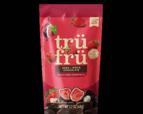 Three packages of Tru Fru freeze-dried strawberry products in bright red packaging with gold logo, showing the dark and white chocolate covered strawberry varieties that are subject to recall.