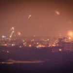 Diwali fireworks burst at night with long-exposure light trails over a dark sky
