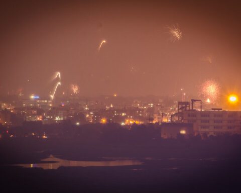 Diwali fireworks burst at night with long-exposure light trails over a dark sky