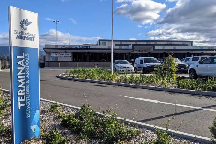 Shellharbour Airport terminal and runway area in New South Wales under clear daylight, representing regional aviation infrastructure.